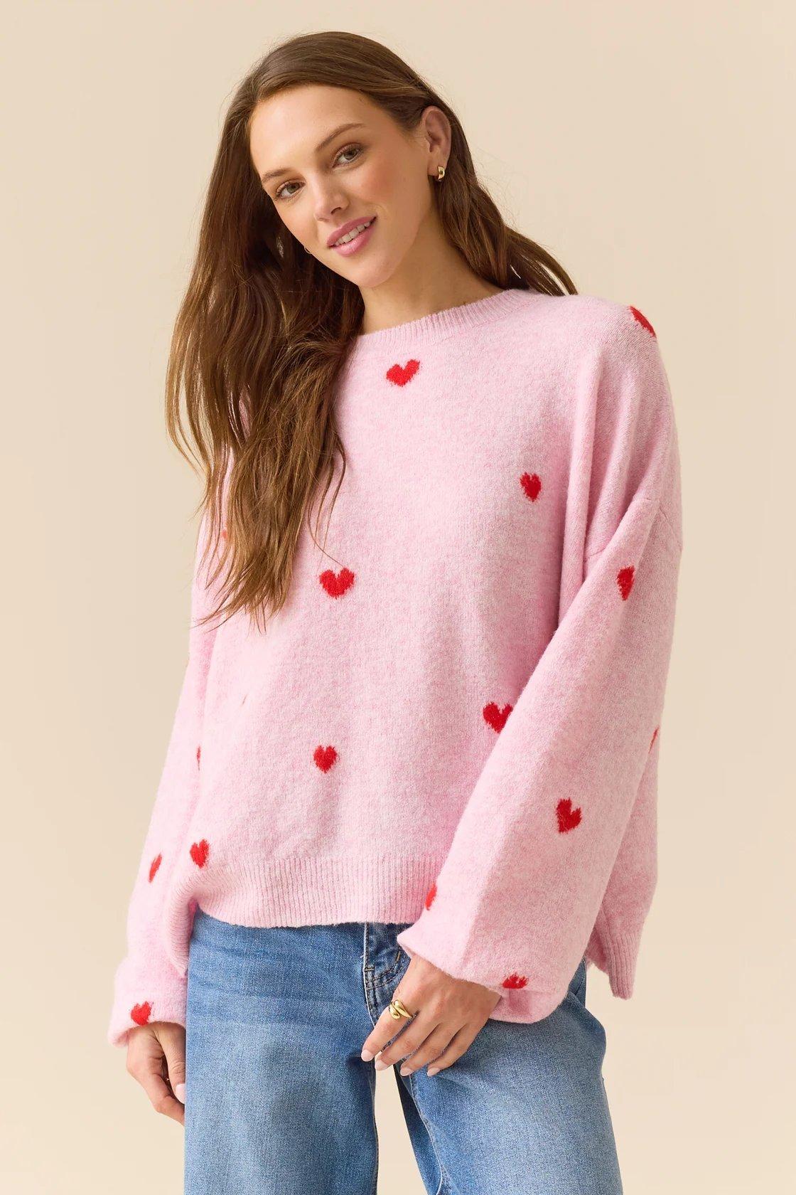 pink pullover with red hearts