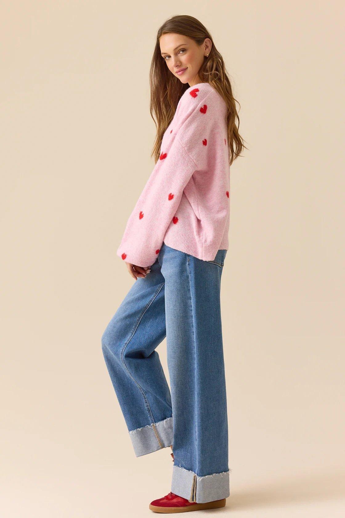 pink pullover with red hearts