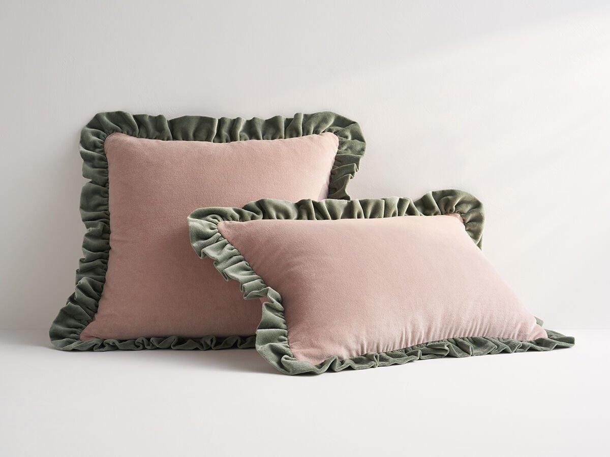 Rose pink colored velvet pillows with green trim