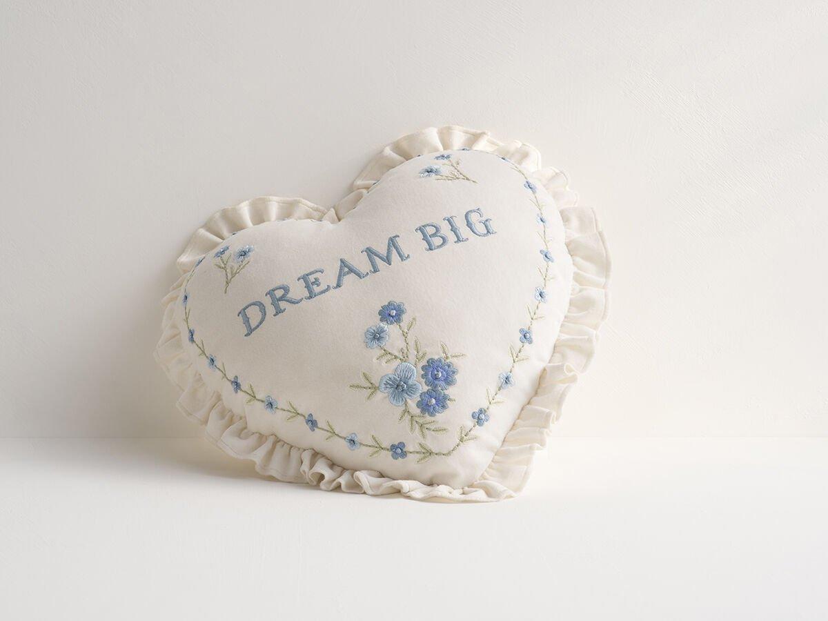 white heart pillow with blue detailing