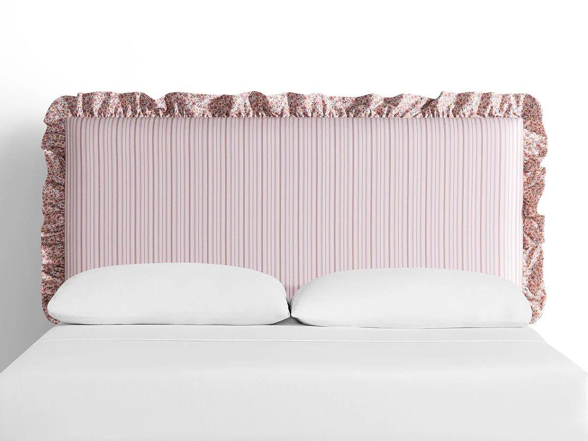 light pink striped upholstered headboard with floral trim