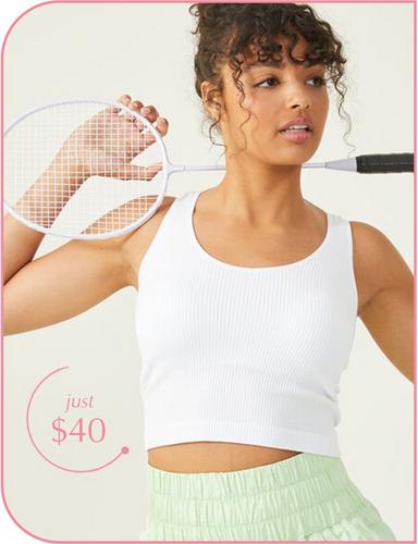 Woman wearing brown flowy workout shorts and a black sports bra.
