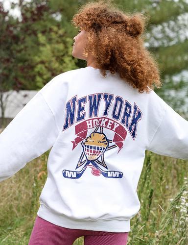 Woman wearing a New York hockey sweatshirt