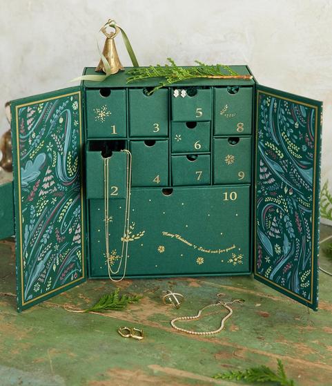 Green jewelry advent calendar with jewelry hanging out