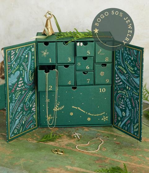 Green jewelry advent calendar with jewelry hanging out