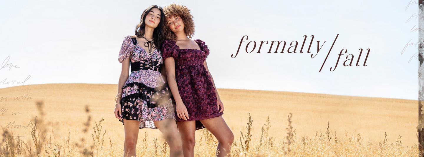 Two women standing in a field wearing mini dresses in various colors