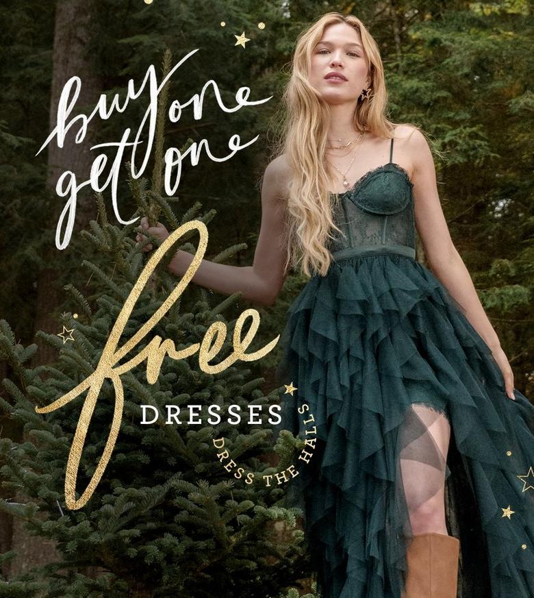 Women wearing green maxi dress next to pine tree
