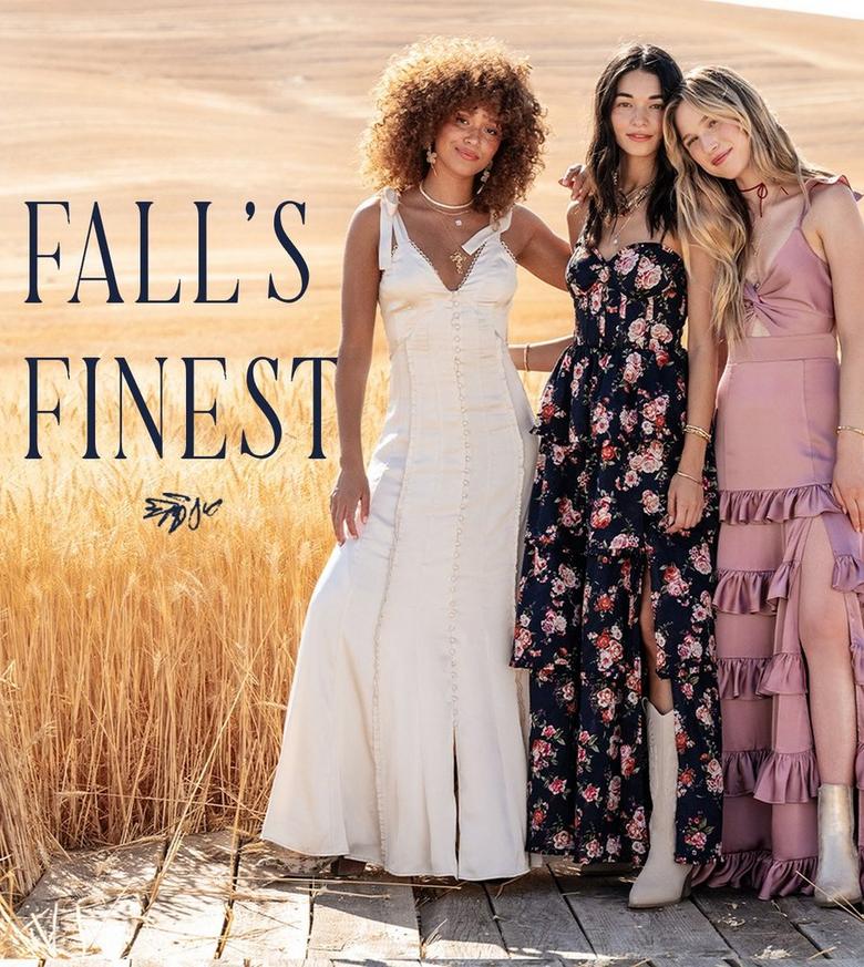 Three women standing in a field wearing special occasion maxi dresses in various colors