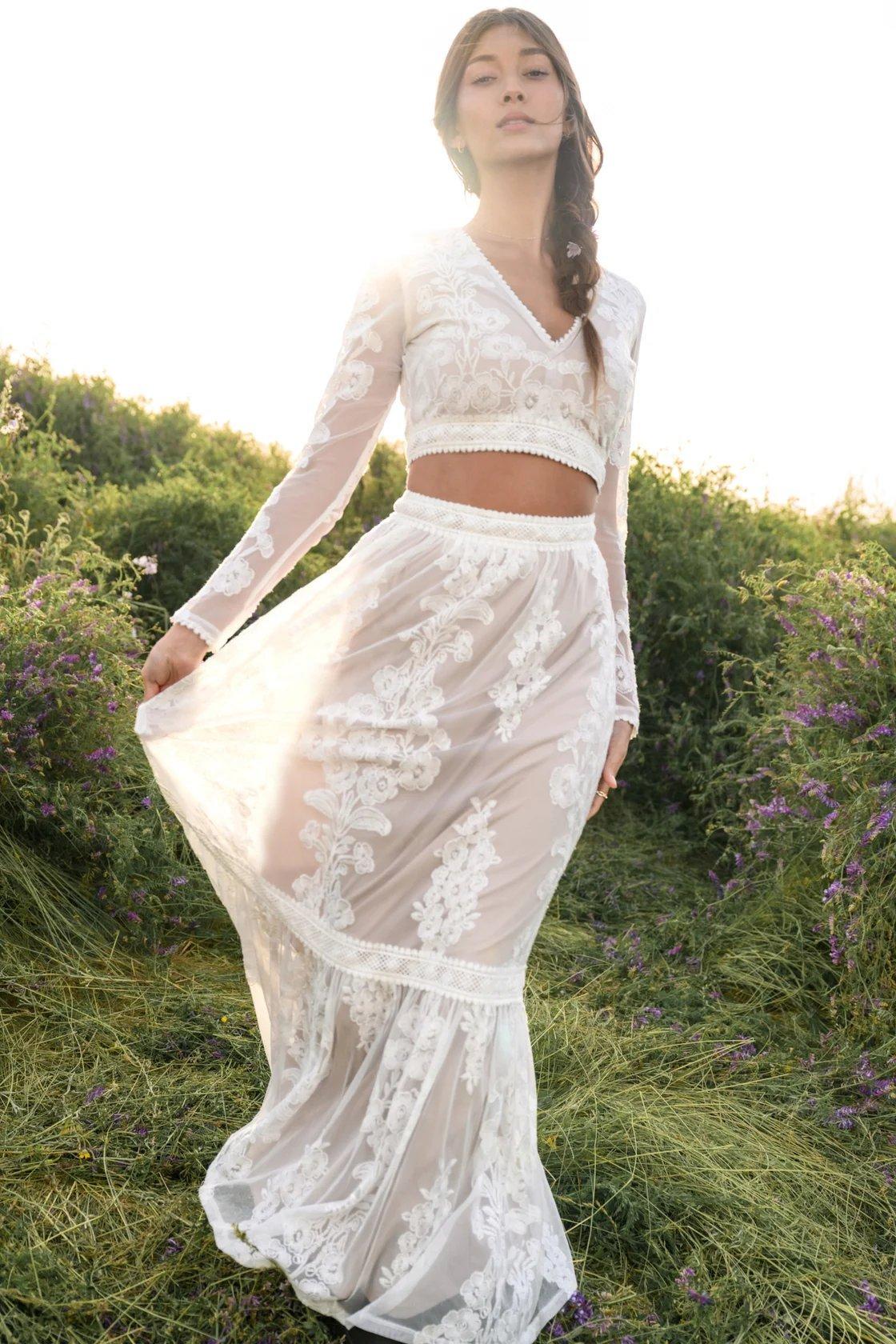 girl wearing a white embroidered maxi skirt