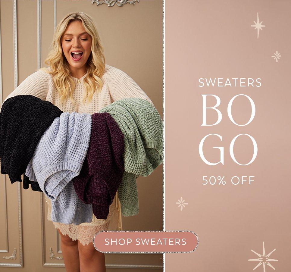 Women holding a variety of colored sweaters