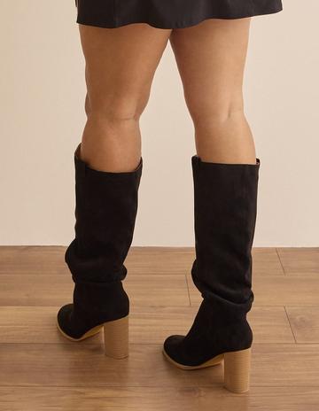 Black mid thigh boots with a heel