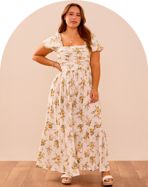 woman wearing a white floral maxi dress