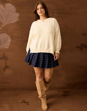 Girl in plaid mini skirt and Tan sweater