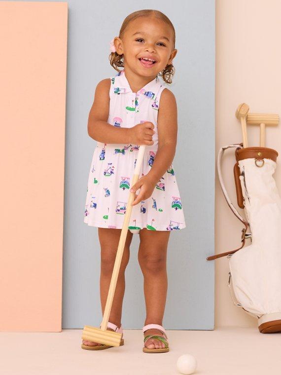 little girl wearing a golf-themed collared dress