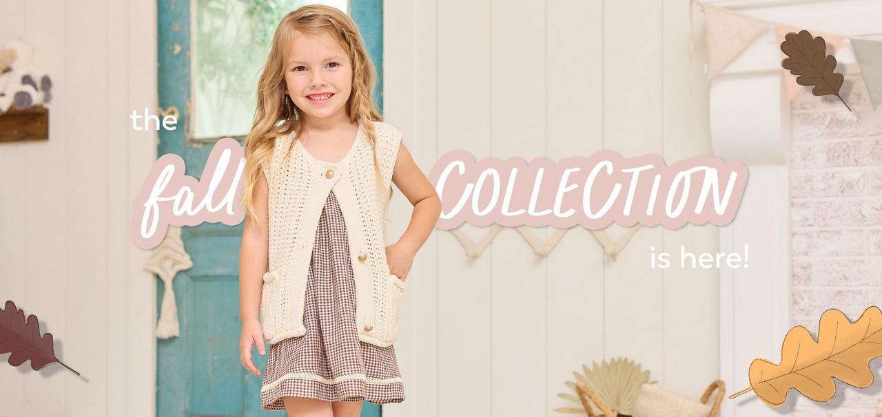 little girl wearing a brown dress and sleeveless cardigan