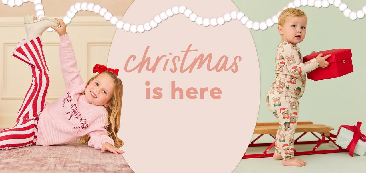 little girl and baby boy wearing a christmas themed set and pajamas