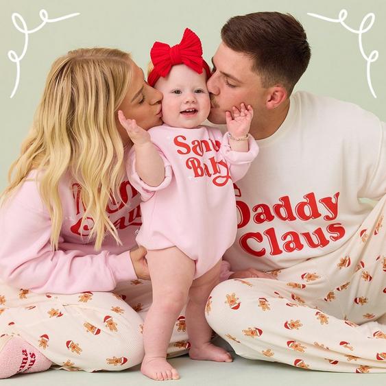 mom, dad, and little girl wearing coordinating christmas pajamas