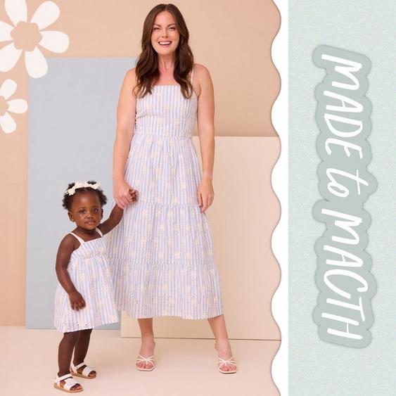 Mom and little girl wearing matching blue stripped dresses