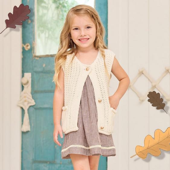 little girl wearing a brown dress and sleeveless cardigan