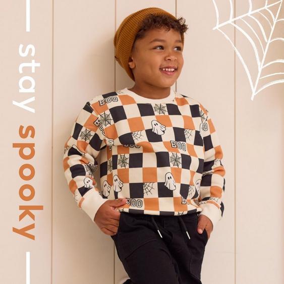 a variety of halloween themed clothing on a young girl, baby boy, and mama and me style
