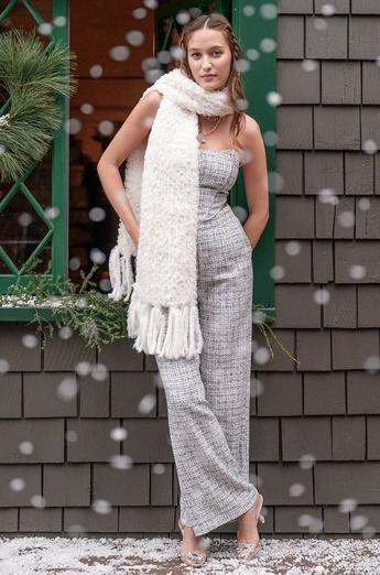 Woman wearing grey pants and top with white scarf