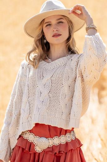 Woman wearing a cream sweater and cream hat