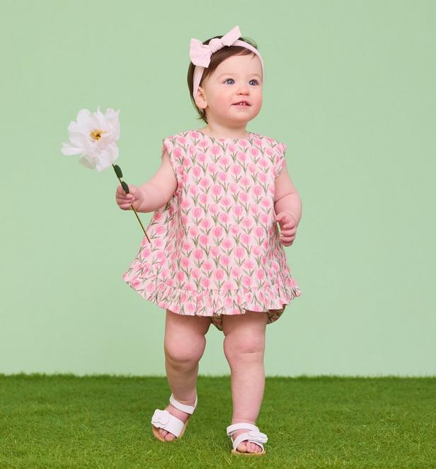 Little girl wearing pink floral set.