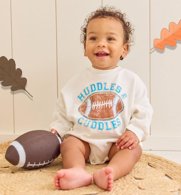 Baby Boy wearing a football bubble