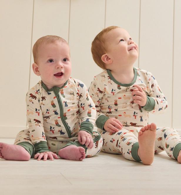 Little boy wearing red white and green Christmas pajamas.