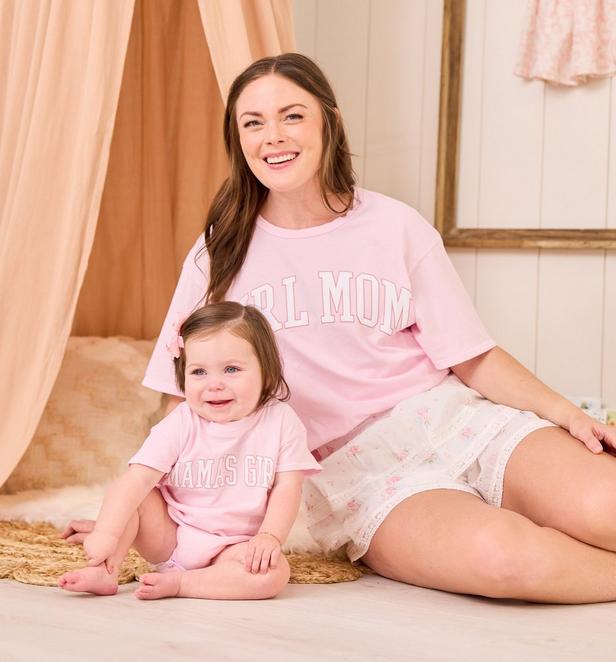 Baby girl and mom wearing matching pink graphic t-shirts.