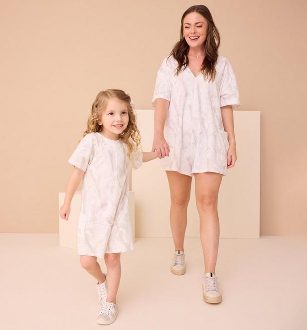 Mama and little girl wearing matching camo rompers.