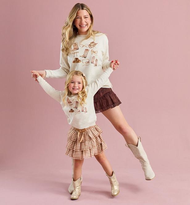 Mama and little girl wearing cowgirl themed pullovers