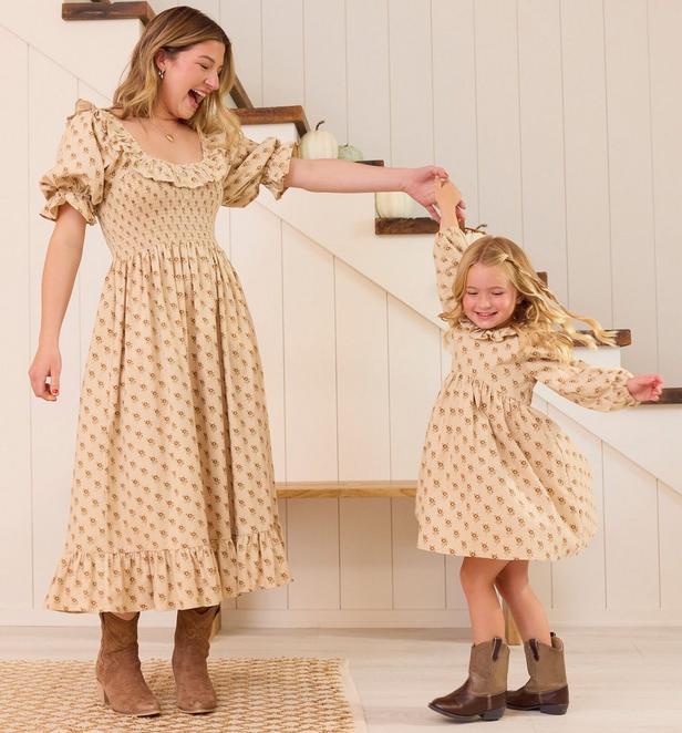 Mama and little girl wearing matching beige and floral dresses