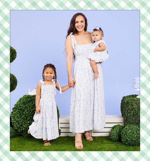 Little girls, and woman wearing matching blue floral dresses.
