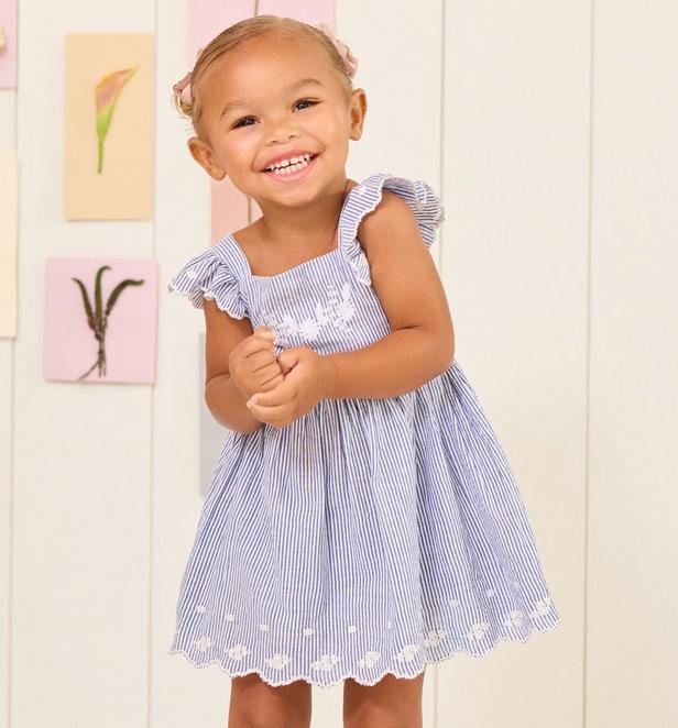 Little girl wearing light blue striped embroidered dress