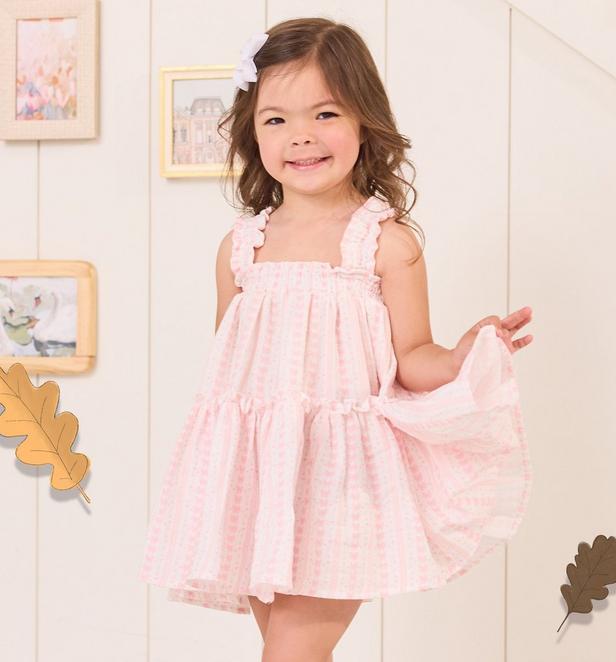Little girl wearing a light blue layered dress