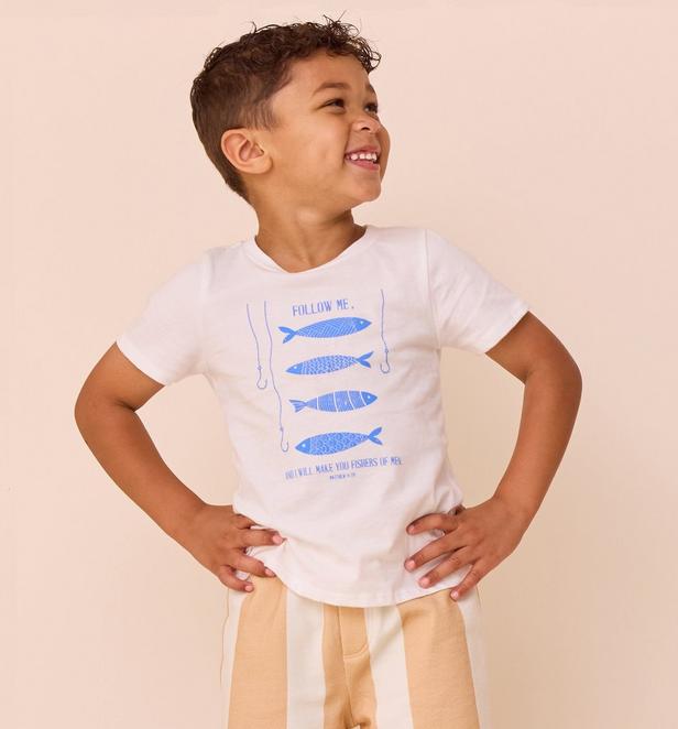 Little boy wearing graphic blue and white tee.