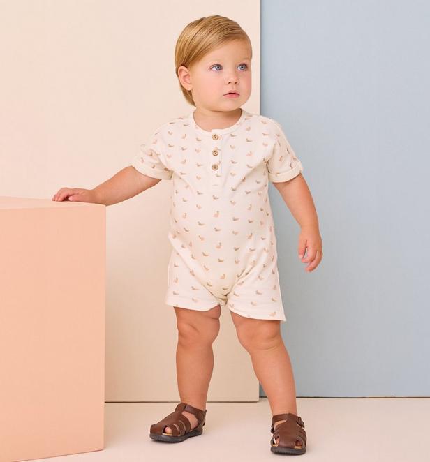 Little boy wearing romper with a duck pattern