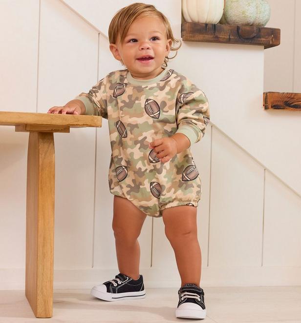 Little boy wearing a camo football themed bubble