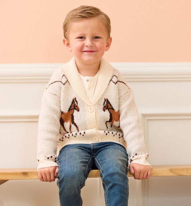 little boy wearing an embroidered horse beige cardigan