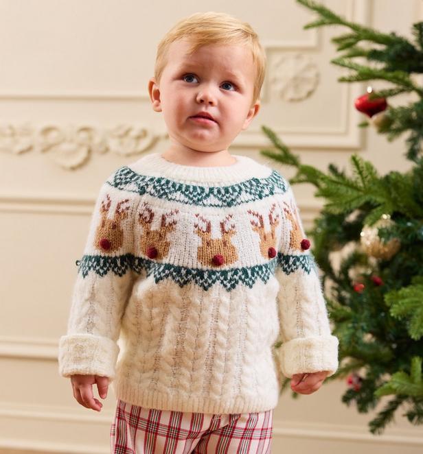 little boy wearing a reindeer sweater