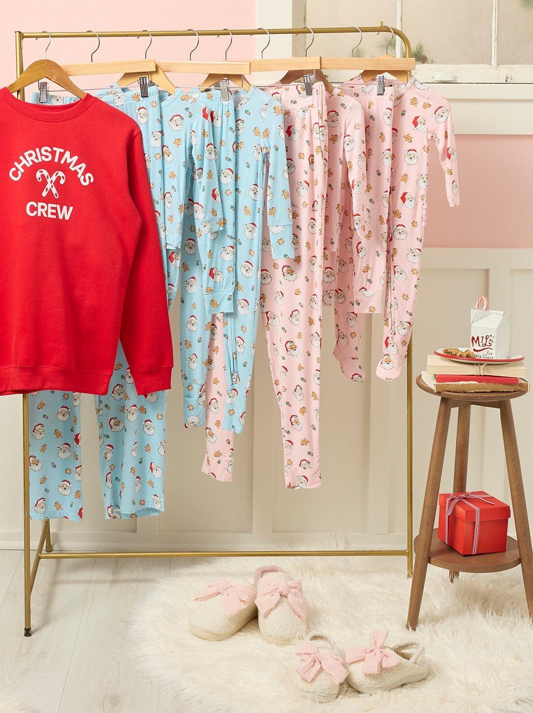 Hanging matching red, blue, and pink pajamas.