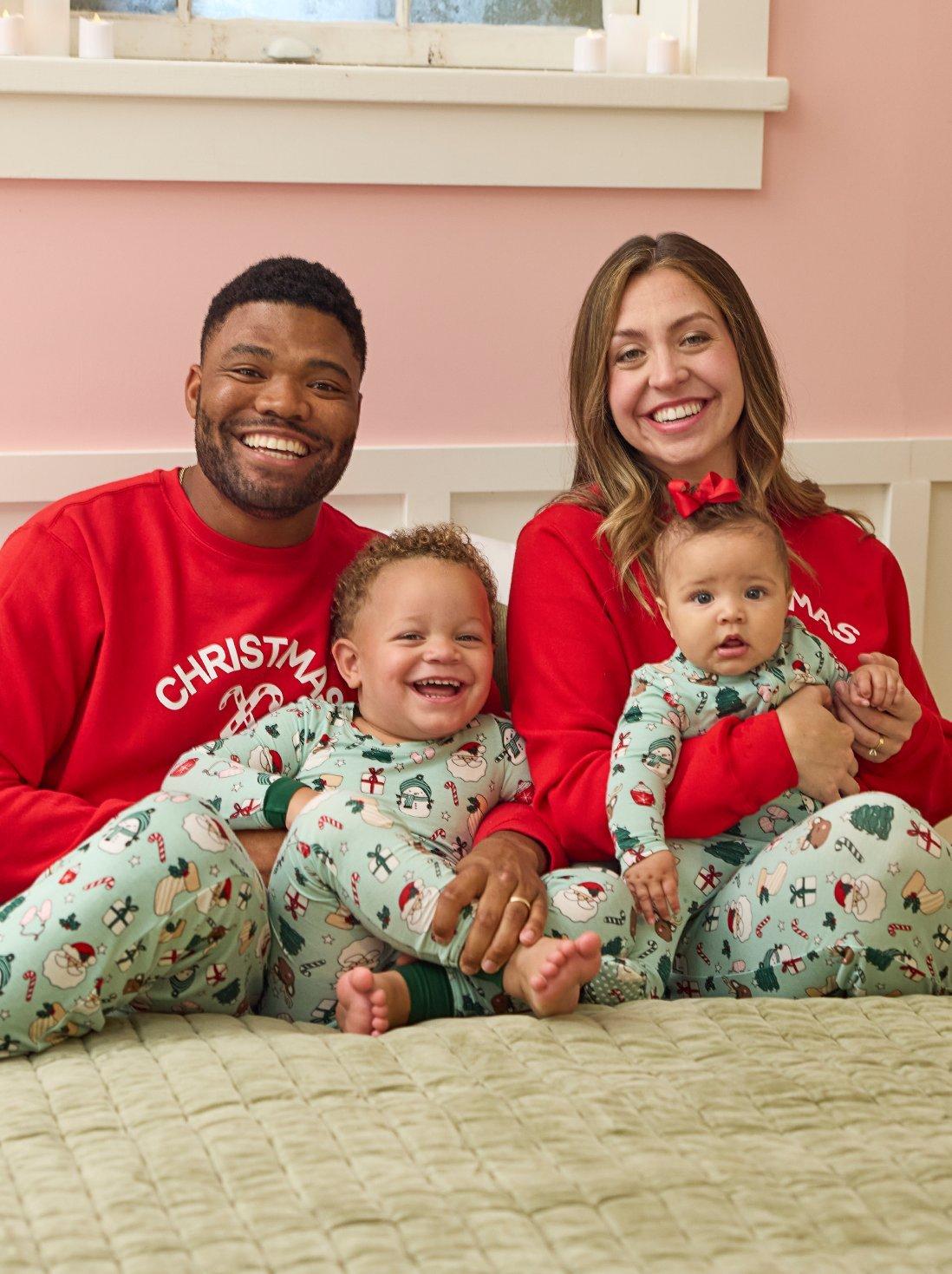 Family wearing matching red and green christmas pajamas.