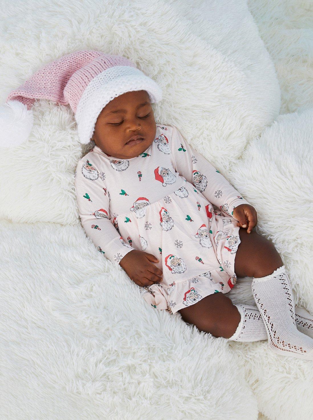 Baby girl wearing pink vintage Santa dress