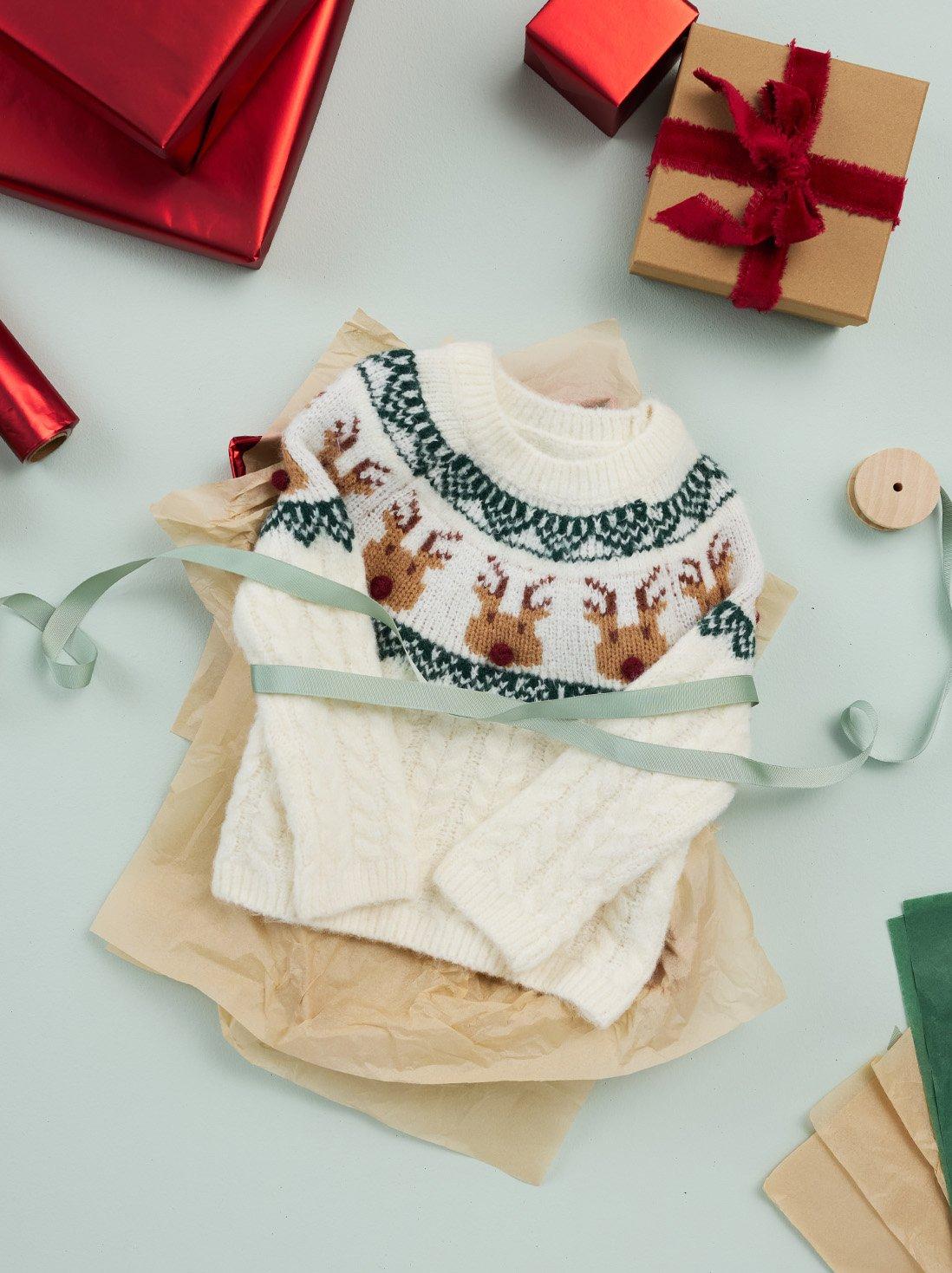 embroidered cream colored reindeer sweater