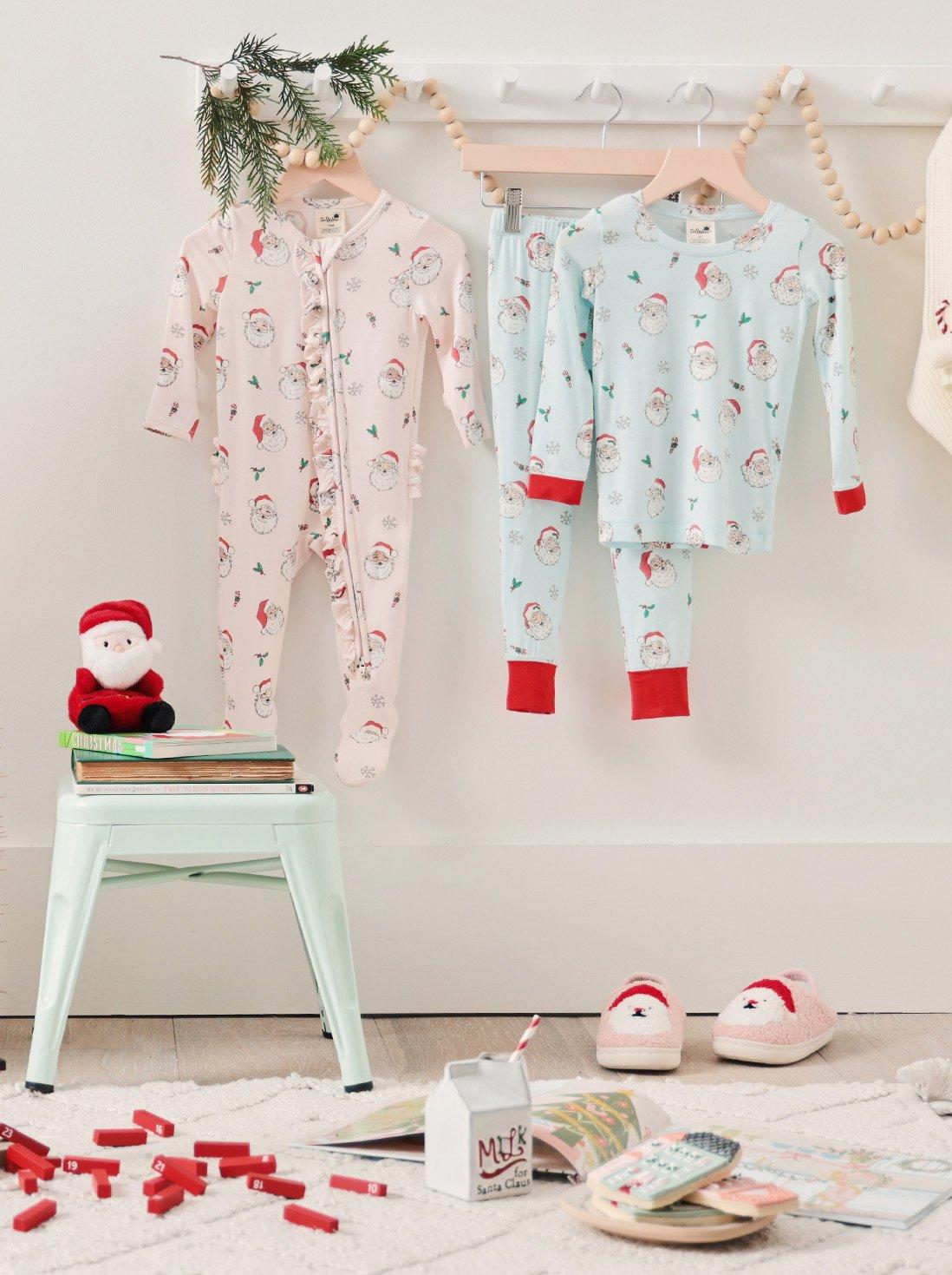 Hanging matching pink and blue vintage santa print pajamas