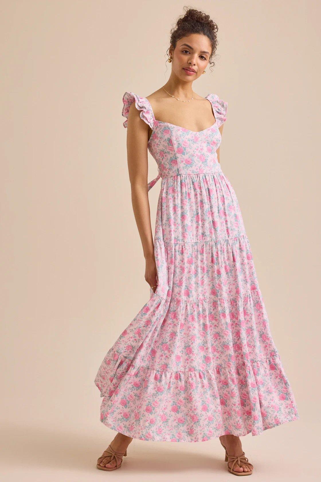 girl wearing a flowy pink floral print maxi dress