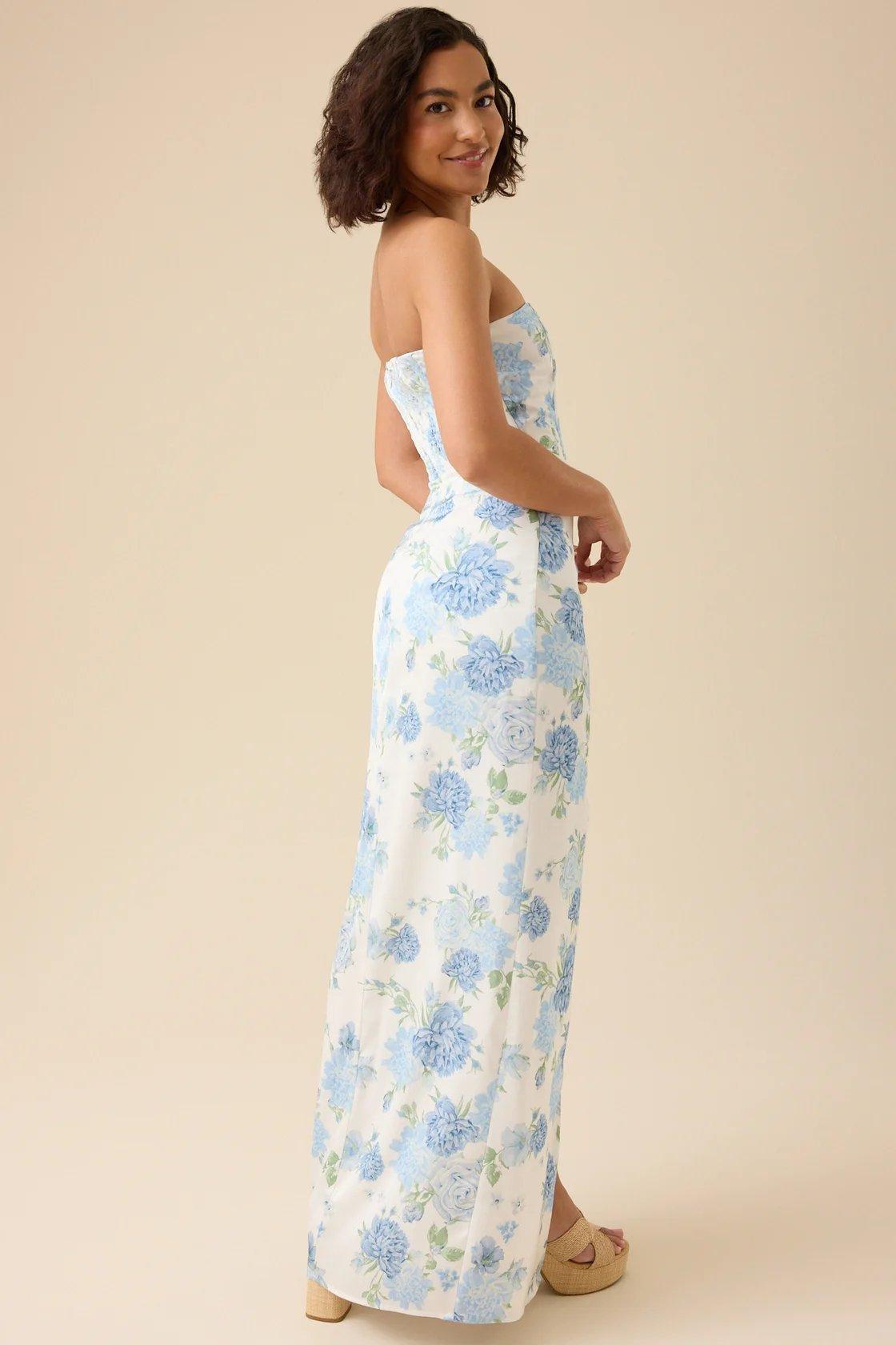 girl wearing a white strapless maxi dress with blue florals