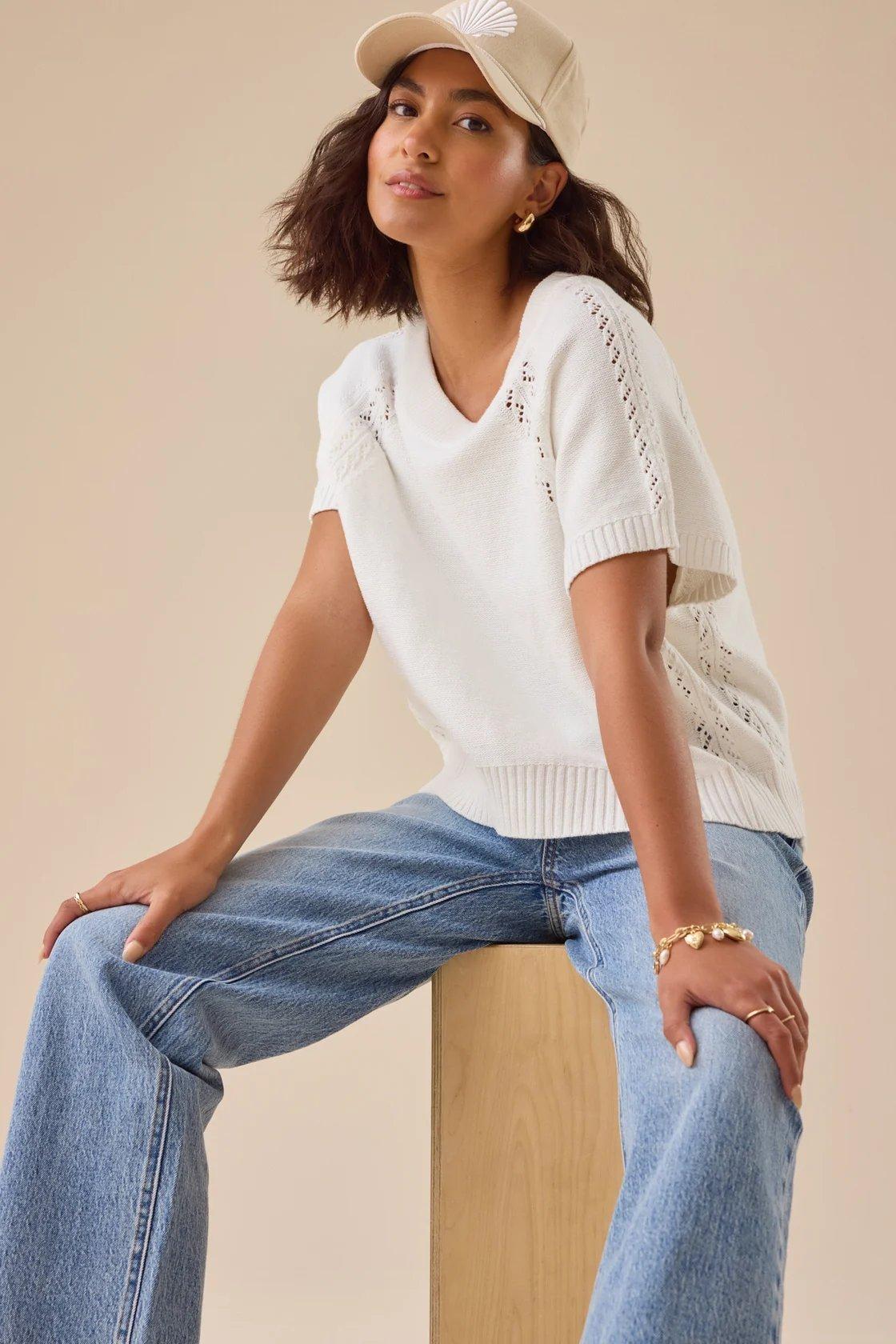 Girl wearing an ivory crocheted pullover
