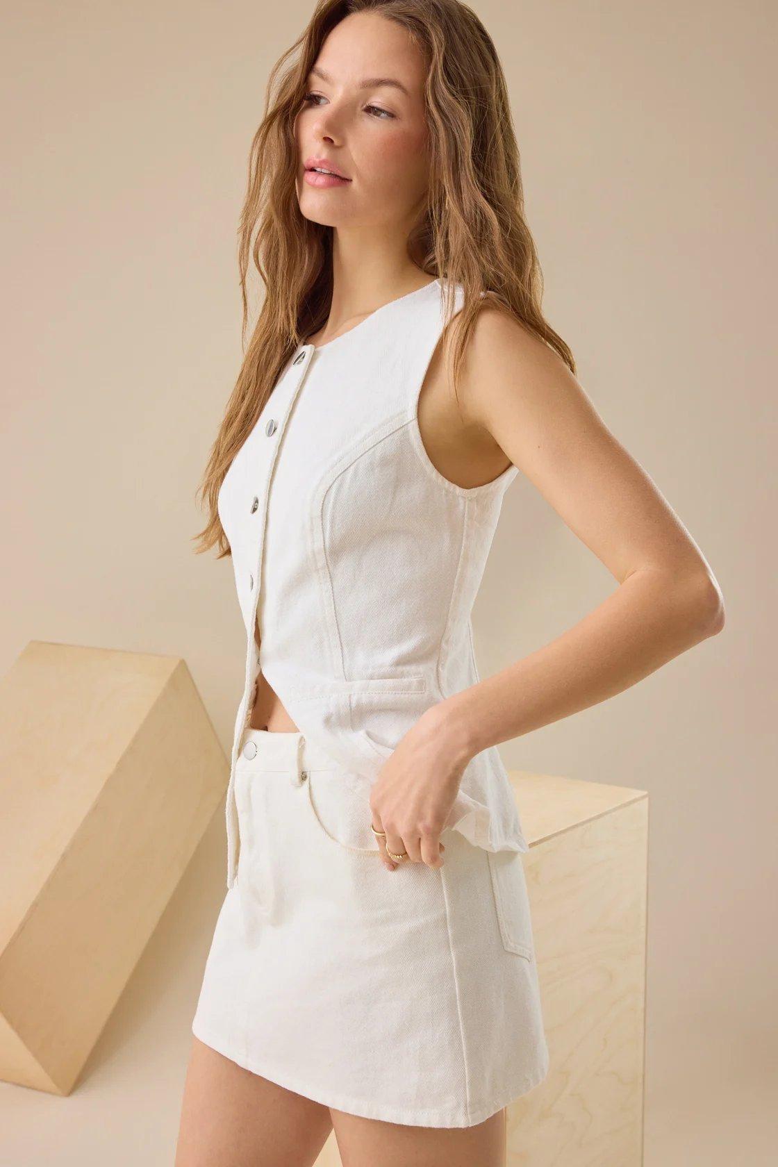 girl wearing a white denim vest and skirt